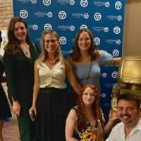 Six alums standing in front of the GV Alumni Relations backdrop.